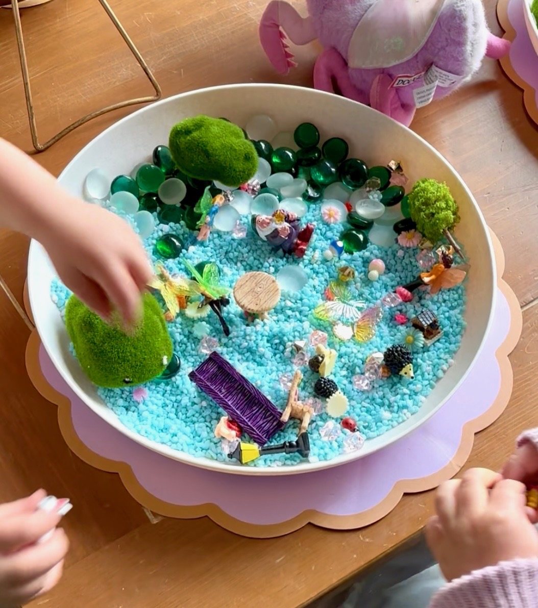 Children gathered around a hands-on PlayLab Co. sensory activity